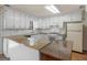 Well-lit kitchen with white cabinetry, granite countertops, and plenty of storage space at 290 Rocky Branch Dr, Mcdonough, GA 30252
