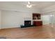 Bright living room featuring a fireplace, built-in cabinet, and wood floors at 290 Rocky Branch Dr, Mcdonough, GA 30252