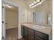 Bright bathroom with dual sinks, granite countertops, and a storage closet at 2389 Aukerman Trce # 79, Hampton, GA 30228