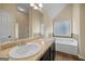 Bathroom featuring dual sinks, granite countertops, and a large bathtub at 2389 Aukerman Trce # 79, Hampton, GA 30228
