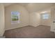 Spacious bedroom with high ceilings, carpet flooring, and two large windows at 2389 Aukerman Trce # 79, Hampton, GA 30228