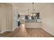 Open-concept kitchen with stainless steel appliances, breakfast bar, and seamless connection to the dining area at 2389 Aukerman Trce # 79, Hampton, GA 30228