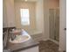 Bright bathroom showcasing a double vanity, garden tub, and glass-enclosed shower at 443 Faulkner St, Stockbridge, GA 30281