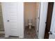 Bathroom features a toilet and a door to glass enclosed shower, with tile floors at 443 Faulkner St, Stockbridge, GA 30281