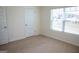 Bedroom with a large window letting in natural light and a five-panel door at 443 Faulkner St, Stockbridge, GA 30281