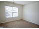 Bedroom featuring a large window providing natural light and neutral carpeting at 443 Faulkner St, Stockbridge, GA 30281