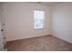 Bedroom featuring a large window providing natural light, neutral carpeting, and neutral walls at 443 Faulkner St, Stockbridge, GA 30281