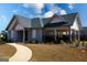 Community clubhouse surrounded by landscaping, on a partially cloudy day at 443 Faulkner St, Stockbridge, GA 30281
