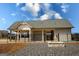 Community clubhouse with a covered patio, an outdoor fireplace, and black metal fencing, offering a perfect spot for gatherings at 443 Faulkner St, Stockbridge, GA 30281