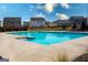 Community pool and surrounding houses in a neighborhood on a partially cloudy day at 443 Faulkner St, Stockbridge, GA 30281