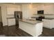 Bright kitchen with white cabinets, granite countertops, stainless steel appliances, and a center island at 443 Faulkner St, Stockbridge, GA 30281