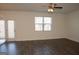 Bright living room with hardwood floors, ceiling fan, a large window and access to the outside at 443 Faulkner St, Stockbridge, GA 30281