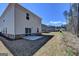 View of backyard with a patio slab, sliding glass door, and view of other homes at 1659 Hay Patch Ln, Loganville, GA 30052