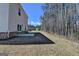 The backyard features a patio, trees and lawn at 1659 Hay Patch Ln, Loganville, GA 30052