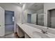 Bathroom featuring double sinks, a walk-in shower, and wood-look flooring at 1659 Hay Patch Ln, Loganville, GA 30052