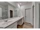 Bathroom featuring double sinks, a large mirror, and wood-look flooring at 1659 Hay Patch Ln, Loganville, GA 30052
