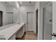 Bathroom showcasing a large mirror, double sinks, and a glass-enclosed shower at 1659 Hay Patch Ln, Loganville, GA 30052