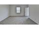 Spacious bedroom with neutral carpet, a window and a door at 1659 Hay Patch Ln, Loganville, GA 30052