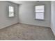 Comfortable carpeted bedroom with natural light from two windows, ideal for rest and relaxation at 1659 Hay Patch Ln, Loganville, GA 30052