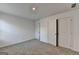 This bedroom features neutral carpeting, white walls, and a closet with doors at 1659 Hay Patch Ln, Loganville, GA 30052