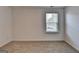 Carpeted bedroom featuring a bright window offering an airy and inviting atmosphere at 1659 Hay Patch Ln, Loganville, GA 30052