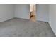 Neutral bedroom featuring soft carpet and freshly painted walls adjacent to bathroom at 1659 Hay Patch Ln, Loganville, GA 30052