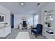Bright bedroom featuring gray carpet, light walls, a desk, and decorative shelving at 1659 Hay Patch Ln, Loganville, GA 30052