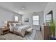 Bedroom features natural light, neutral decor, ceiling fan, and comfortable furnishings at 1659 Hay Patch Ln, Loganville, GA 30052