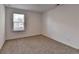 A well-lit bedroom with carpet, a large window, and ample natural light at 1659 Hay Patch Ln, Loganville, GA 30052