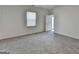 Neutral bedroom featuring light gray carpet, a window and a door at 1659 Hay Patch Ln, Loganville, GA 30052