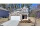 Charming brick two-story home features a manicured front yard and attached two car garage at 1659 Hay Patch Ln, Loganville, GA 30052