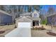 Charming brick two-story home features a manicured front yard and attached two car garage at 1659 Hay Patch Ln, Loganville, GA 30052