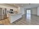 Open-concept kitchen with stainless steel appliances, large island, and hardwood floors at 1659 Hay Patch Ln, Loganville, GA 30052
