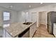 Bright kitchen island features stainless steel dishwasher and double sink at 1659 Hay Patch Ln, Loganville, GA 30052