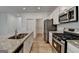 Open-concept kitchen with stainless steel appliances and large island at 1659 Hay Patch Ln, Loganville, GA 30052