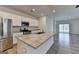 Bright kitchen boasts a large island, stainless steel appliances, and hardwood floors at 1659 Hay Patch Ln, Loganville, GA 30052
