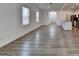 Sunlit living room featuring durable floors and an open layout to the kitchen area at 1659 Hay Patch Ln, Loganville, GA 30052