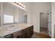 Bright bathroom with double vanity, a large mirror, and a walk-in closet at 2376 Aukerman Trce, Hampton, GA 30228