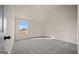 Comfortable bedroom featuring a window, plush carpet, and modern touches at 2376 Aukerman Trce, Hampton, GA 30228