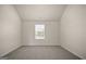 Cozy bedroom with neutral tones, soft carpet, and natural light streaming through the window at 2376 Aukerman Trce, Hampton, GA 30228