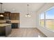 Eat-in kitchen area featuring lots of light, brown cabinets, granite countertops and stainless steel appliances at 2376 Aukerman Trce, Hampton, GA 30228