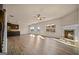 Open-concept living room featuring a cozy fireplace, wood floors, and lots of natural light at 2376 Aukerman Trce, Hampton, GA 30228