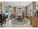 Sunlit dining room featuring a chandelier, large windows, and elegant decor, perfect for Gathering gatherings at 221 Collierstown Way, Peachtree City, GA 30269