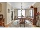 Elegant dining room featuring hardwood flooring, chandelier, and display cabinet at 221 Collierstown Way, Peachtree City, GA 30269