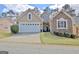 Charming home with a two-car garage and stone and stucco exterior at 221 Collierstown Way, Peachtree City, GA 30269