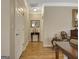 Hallway with wood-look flooring, white trim and doors, and decorative table and chair at 221 Collierstown Way, Peachtree City, GA 30269