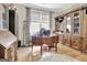 Wood-floored home office featuring a classic wood desk, built-in shelving and a large window for natural light at 221 Collierstown Way, Peachtree City, GA 30269