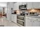 Well-lit kitchen featuring stainless steel appliances, granite countertops, double oven, and tile backsplash at 221 Collierstown Way, Peachtree City, GA 30269