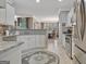 Bright kitchen with white cabinets, granite countertops, stainless steel appliances, and tile flooring at 221 Collierstown Way, Peachtree City, GA 30269