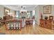 Cozy living room with a fireplace, wood flooring, plush furniture, and ample natural light from large windows at 221 Collierstown Way, Peachtree City, GA 30269
